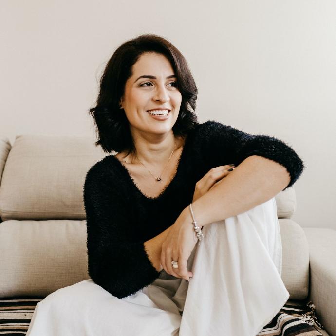 woman in black long sleeve shirt sitting on white couch